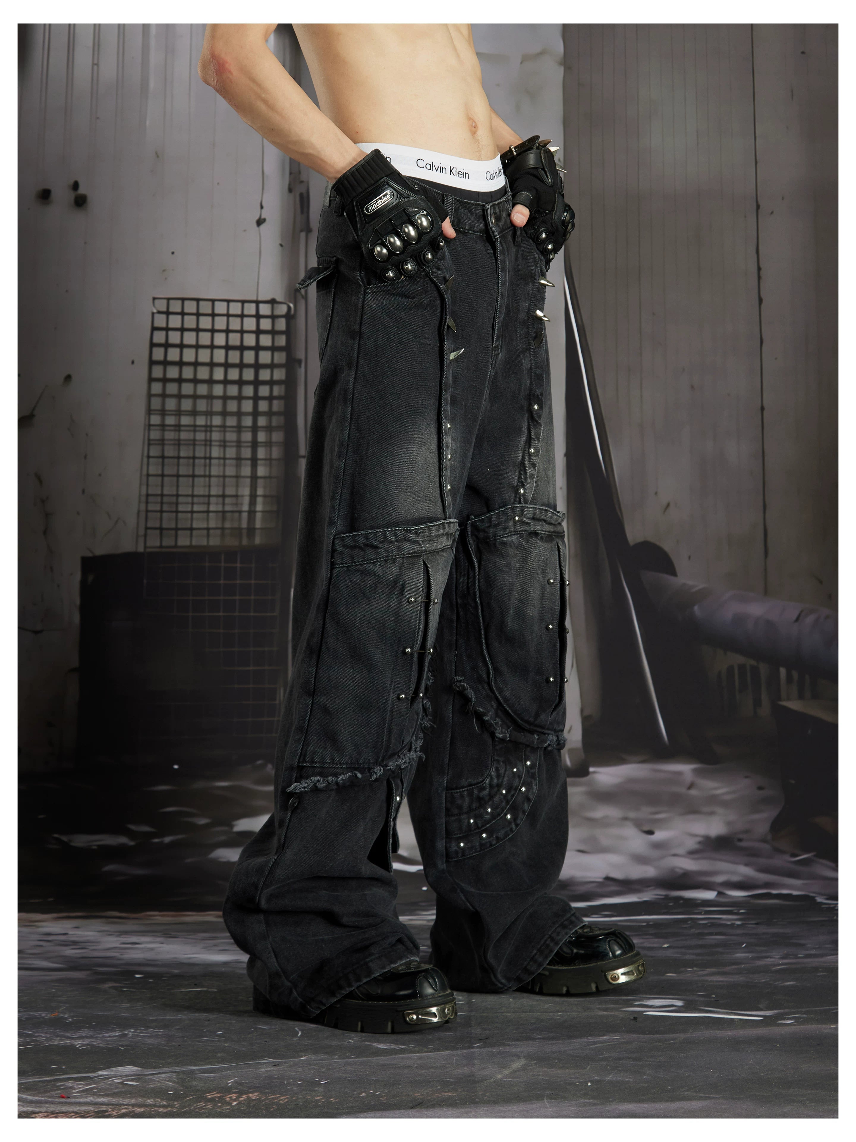 NOMANIAI  Panel-construction straight-leg jeans with rivets and a distressed wash.