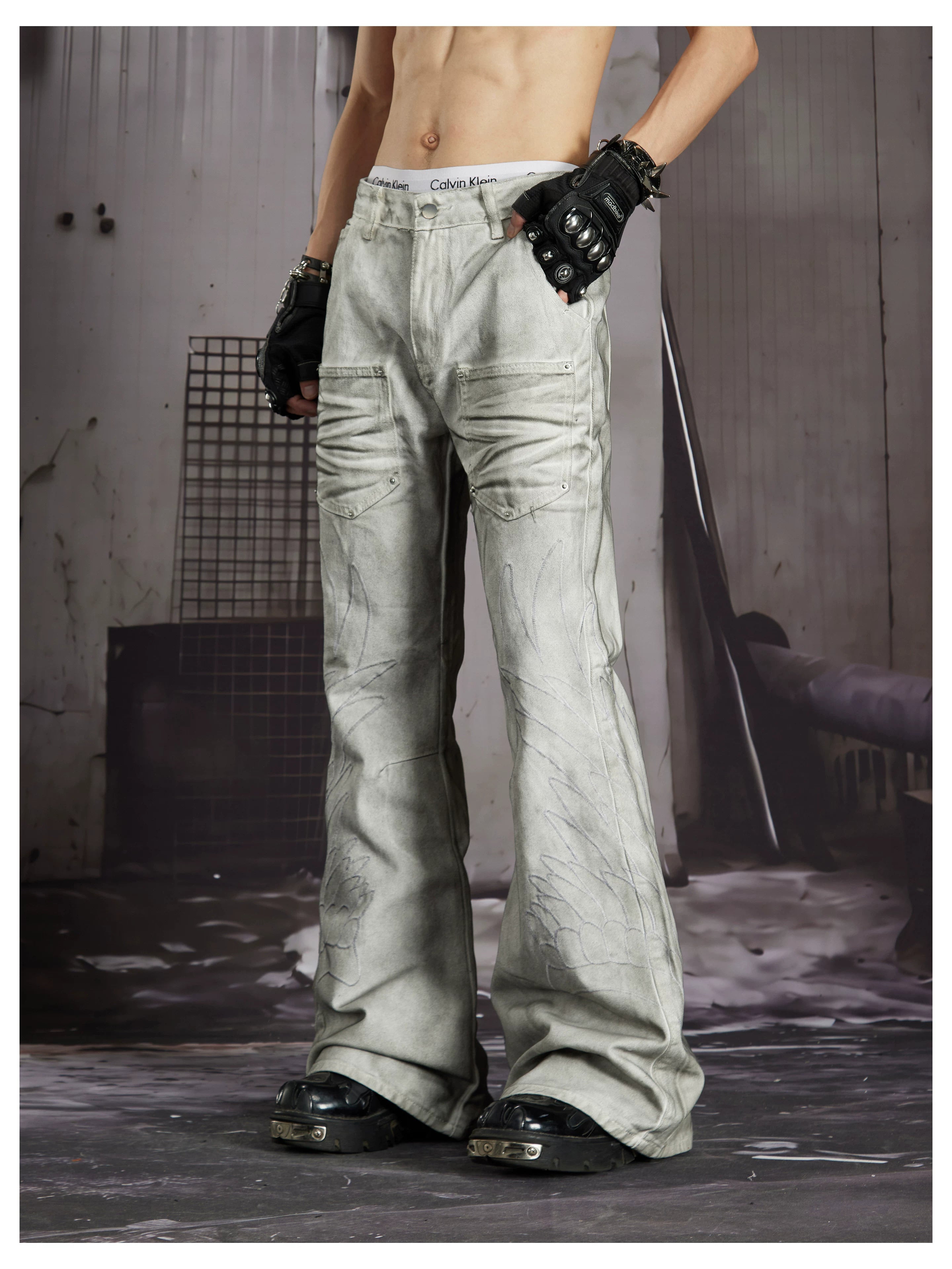 NOMANIAI Dark Street-Style Denim Jeans with Angel Wing Embroidery and Studs.