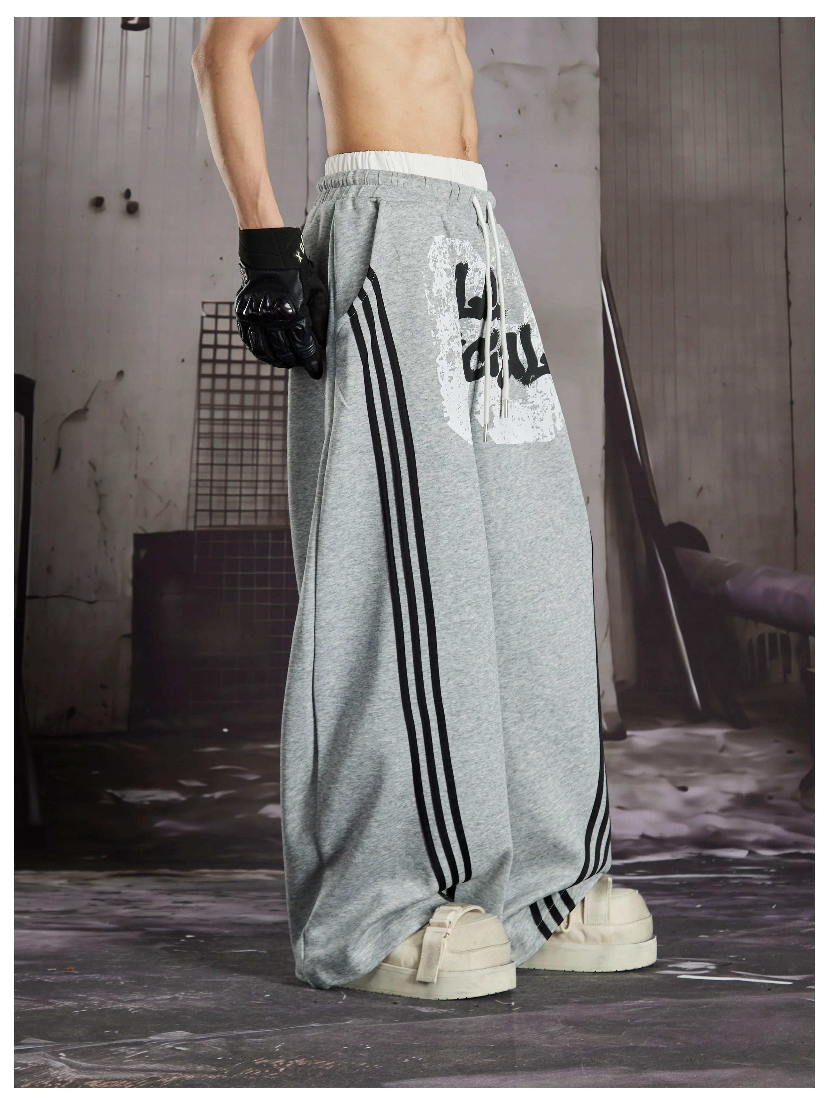 NOMANIAI  Y2K Graffiti-Print Casual Pants with Double-Layer Waistband and Three-Stripe Detail.
