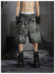 NOMANIAI Y2K loose-fit denim shorts with hand-drawn motifs and studs.