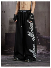 NOMANIAI  Loose-fit casual trousers with double-waistband design and totem print.