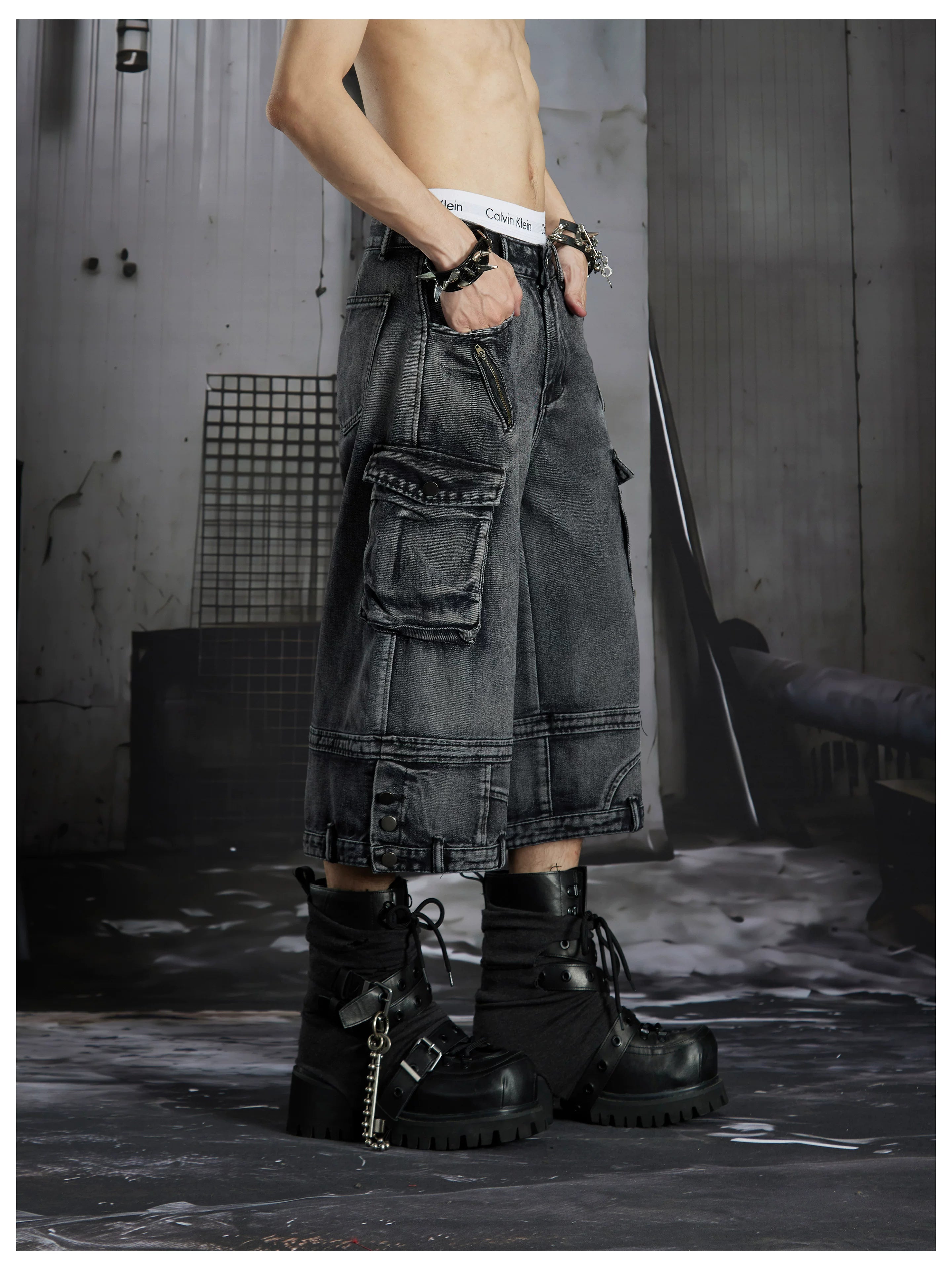NOMANIAI  Washed, distressed, loose-fit cropped pants with multiple pockets.