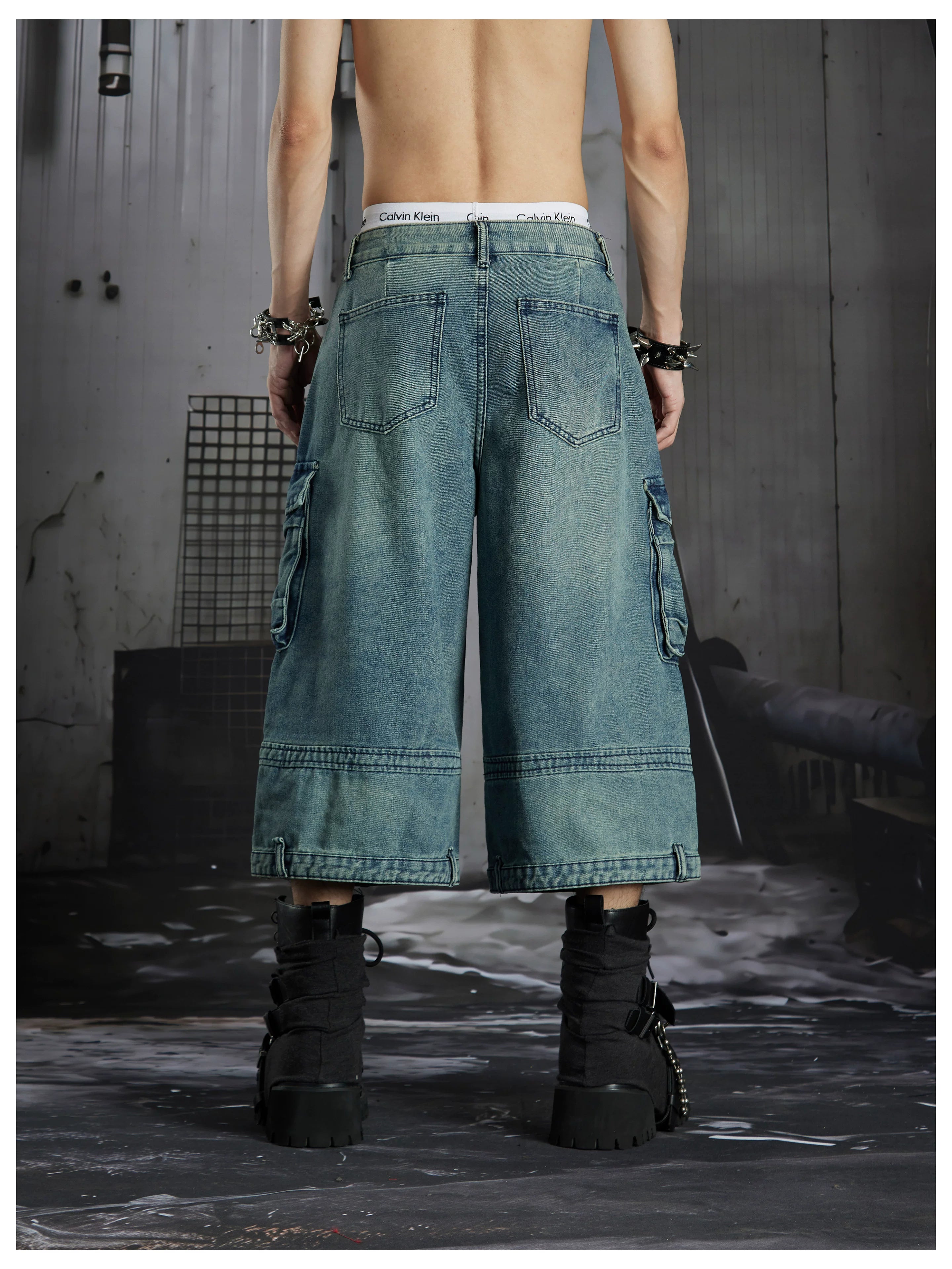 NOMANIAI  Washed, distressed, loose-fit cropped pants with multiple pockets.
