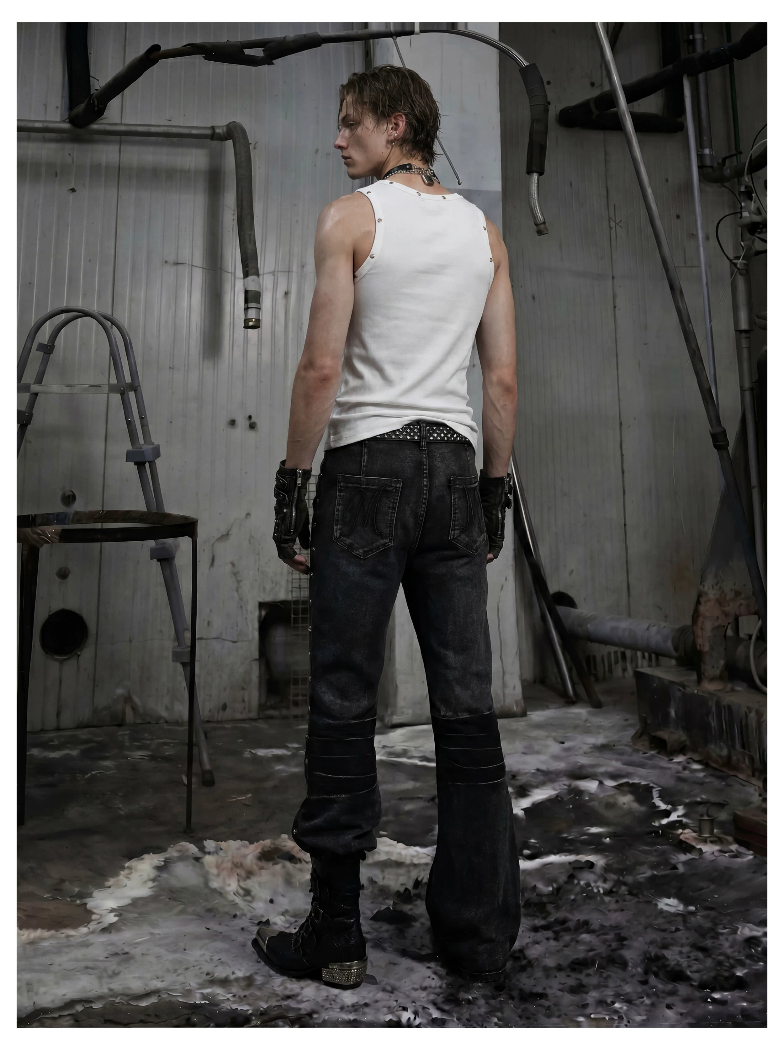 NOMANIAI Distressed, slim-fit, slight-flare jeans with studs—dark streetwear style.