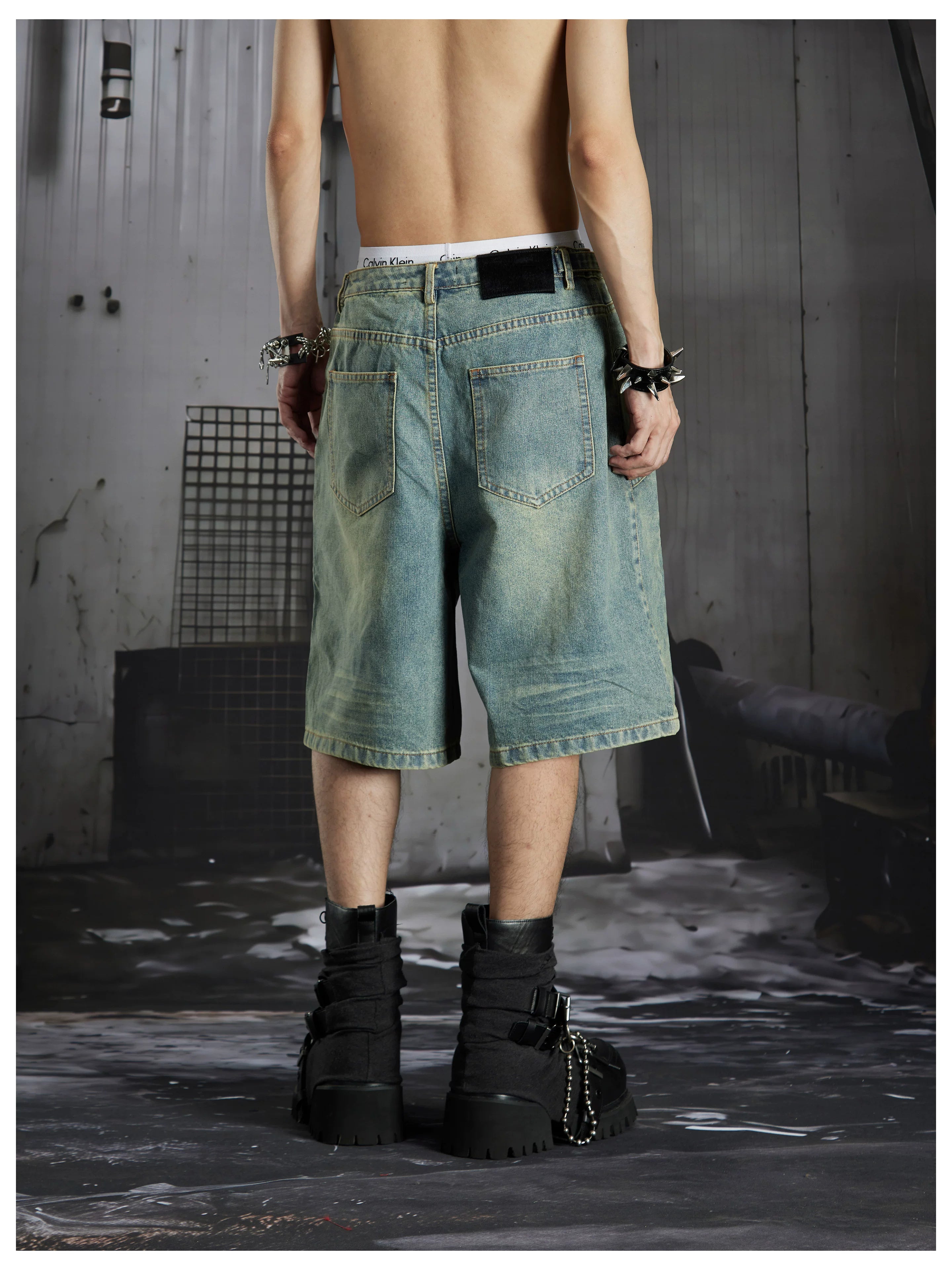 NOMANIAI Deconstructed double-waistband distressed loose-fit denim shorts.
