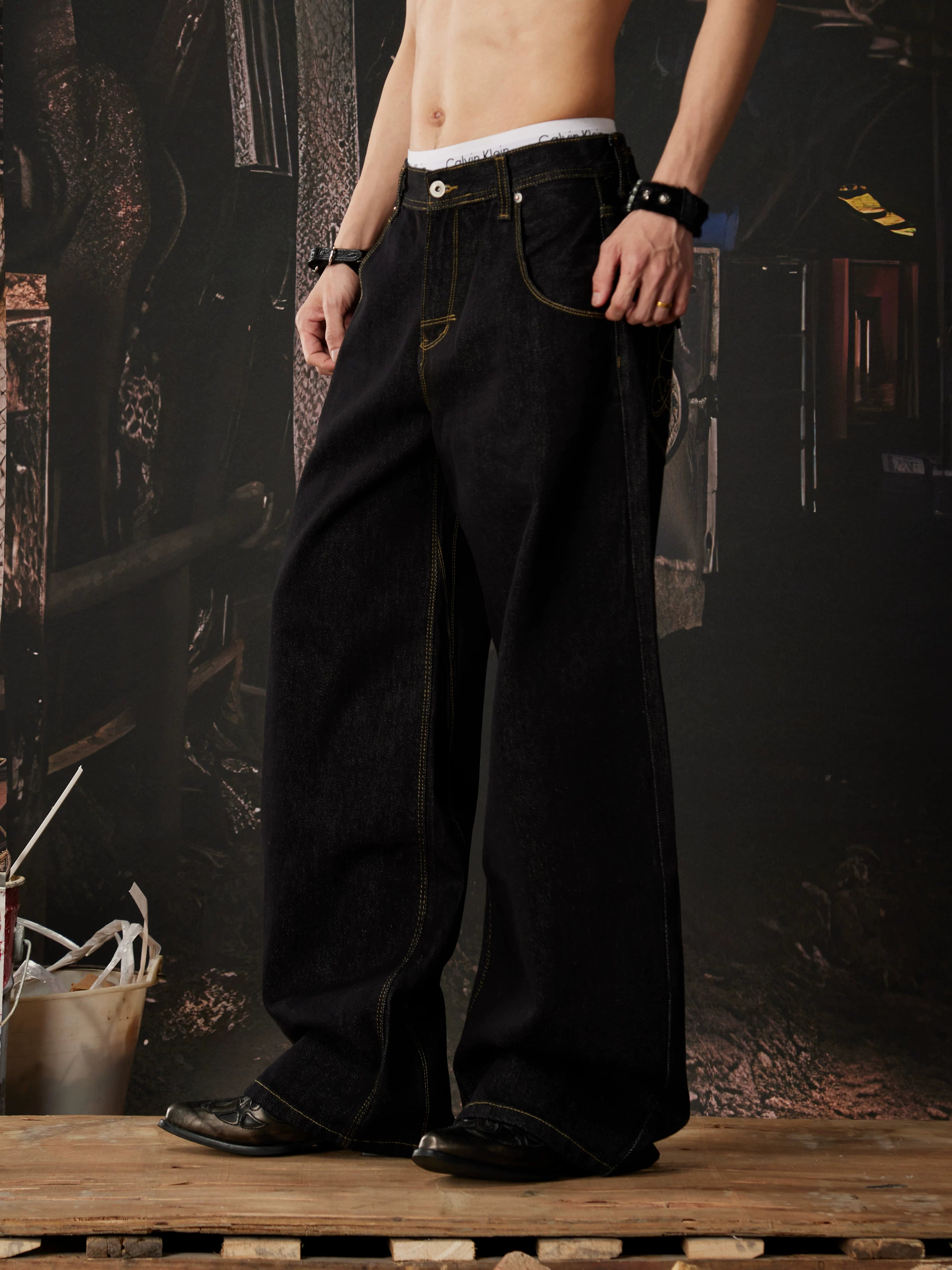 NOMANIAI  Embroidered-waistband loose-fit jeans.