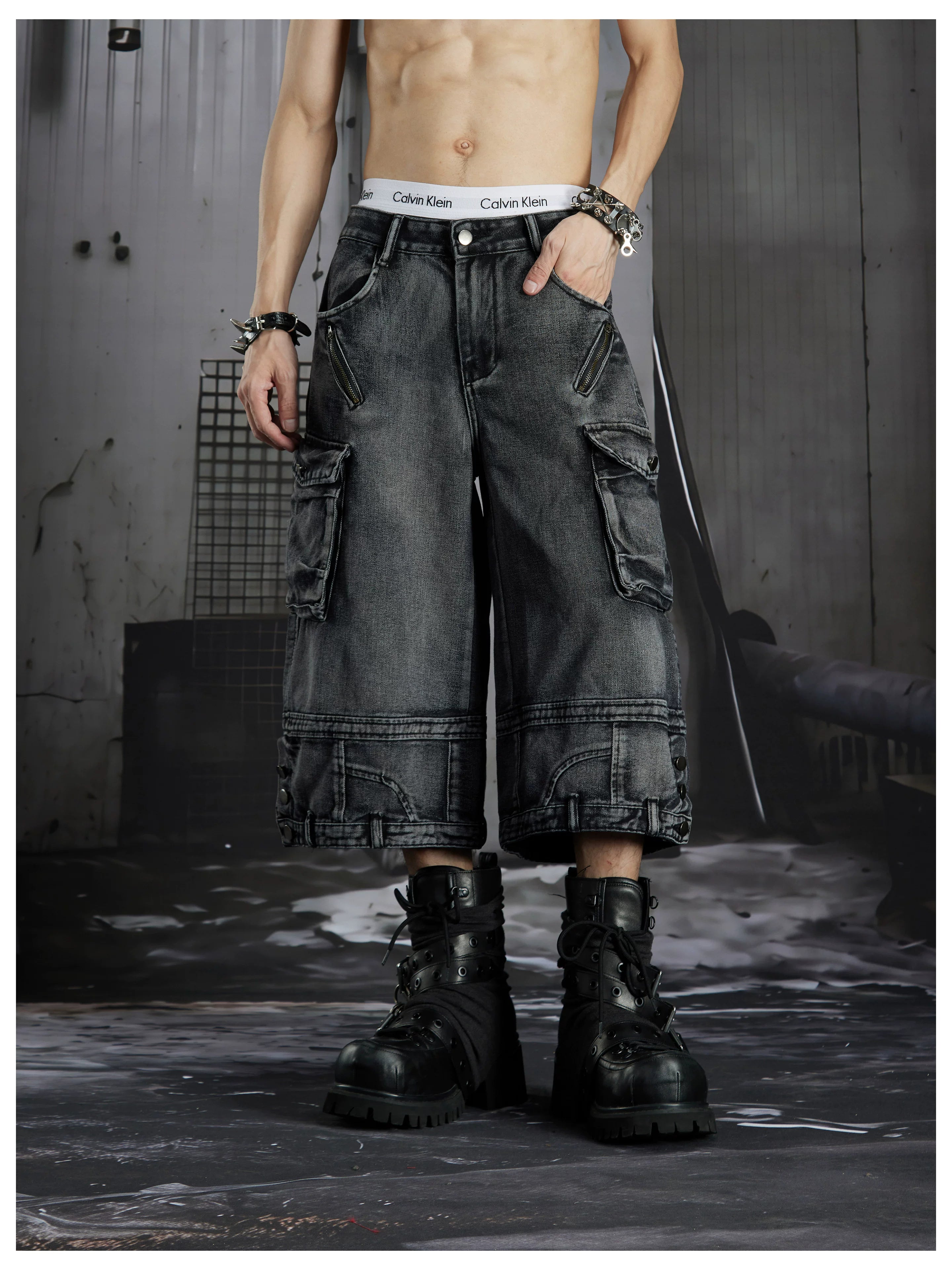 NOMANIAI  Washed, distressed, loose-fit cropped pants with multiple pockets.