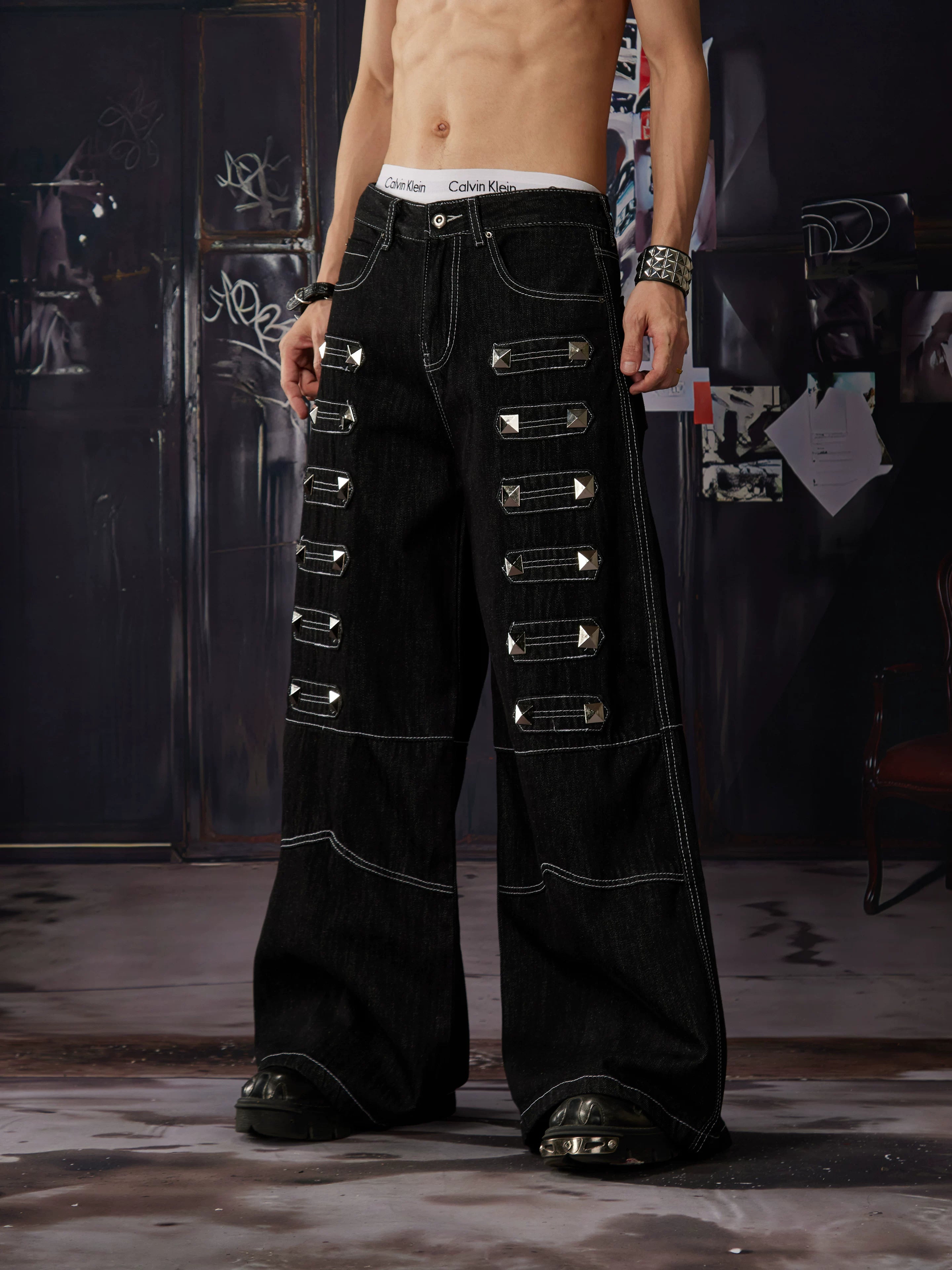 NOMANIAI Y2K-style straight-leg jeans featuring large, dimensional square studs and a distinctive look.