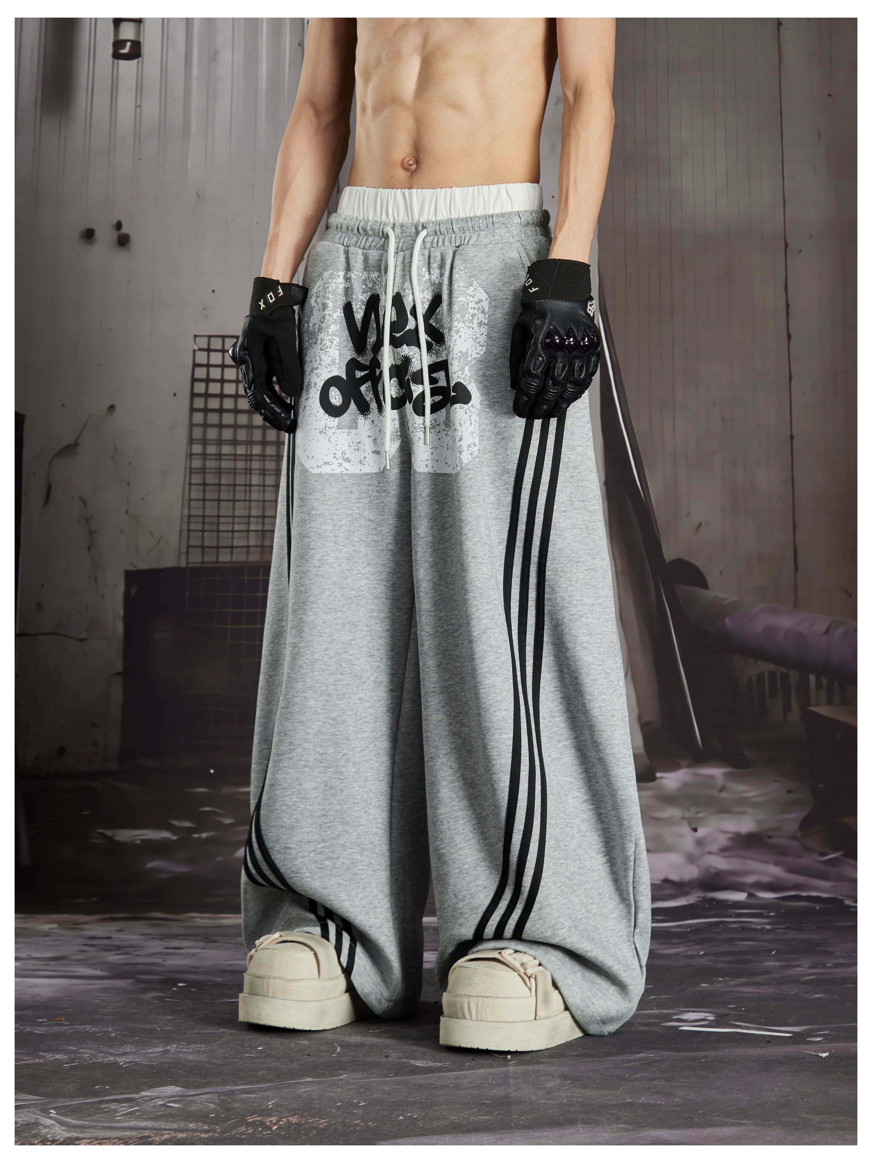 NOMANIAI  Y2K Graffiti-Print Casual Pants with Double-Layer Waistband and Three-Stripe Detail.