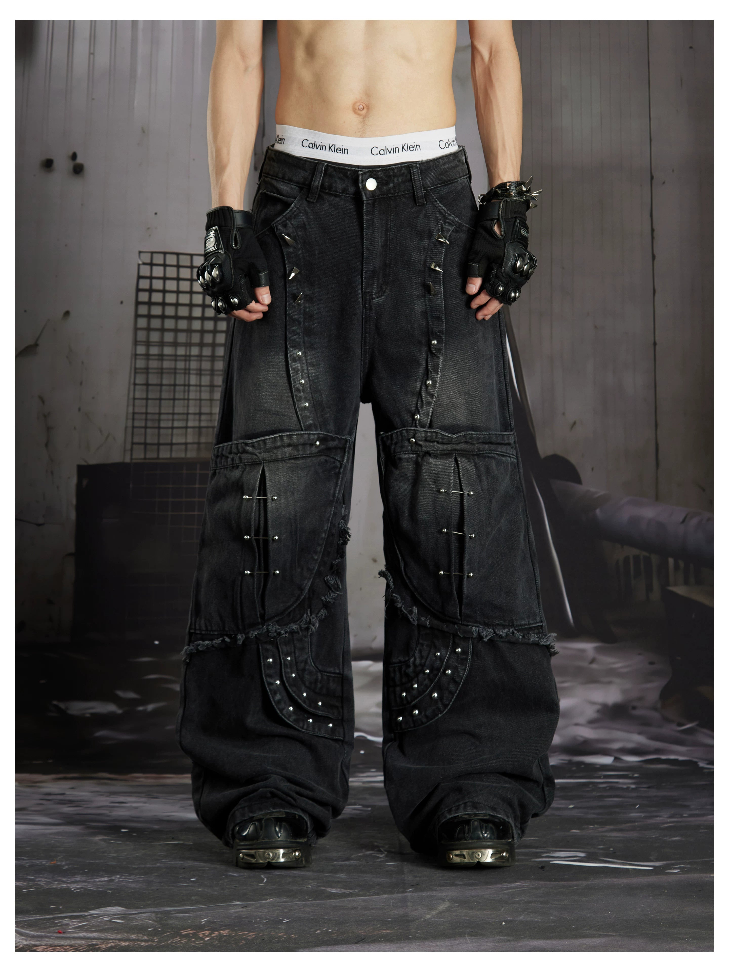 NOMANIAI  Panel-construction straight-leg jeans with rivets and a distressed wash.
