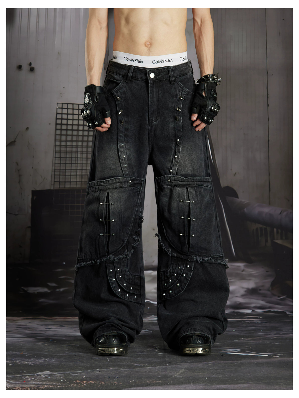 NOMANIAI  Panel-construction straight-leg jeans with rivets and a distressed wash.