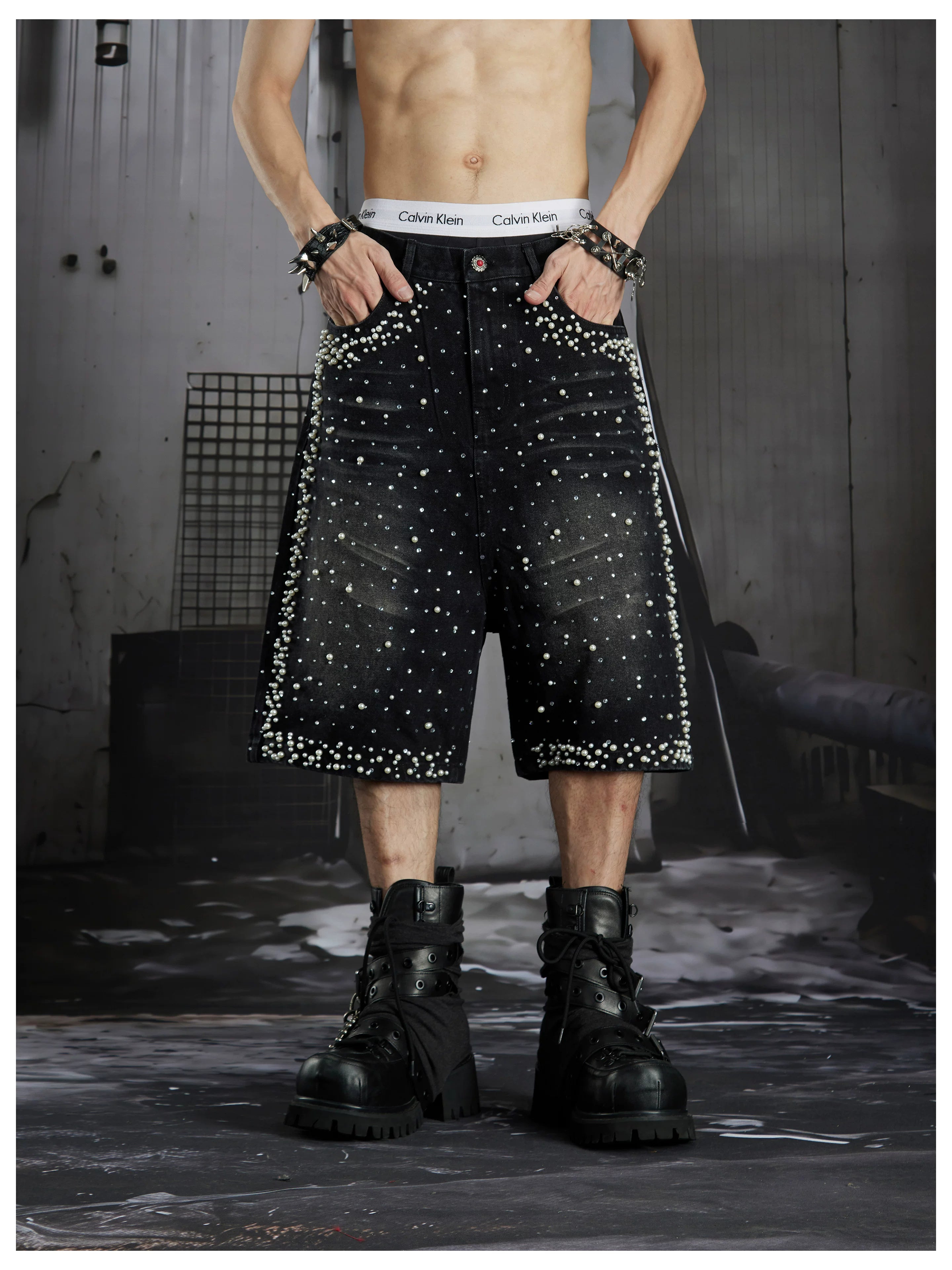 NOMANIAI  Oversized, cropped, studded denim jeans with a punk-style distressed wash.