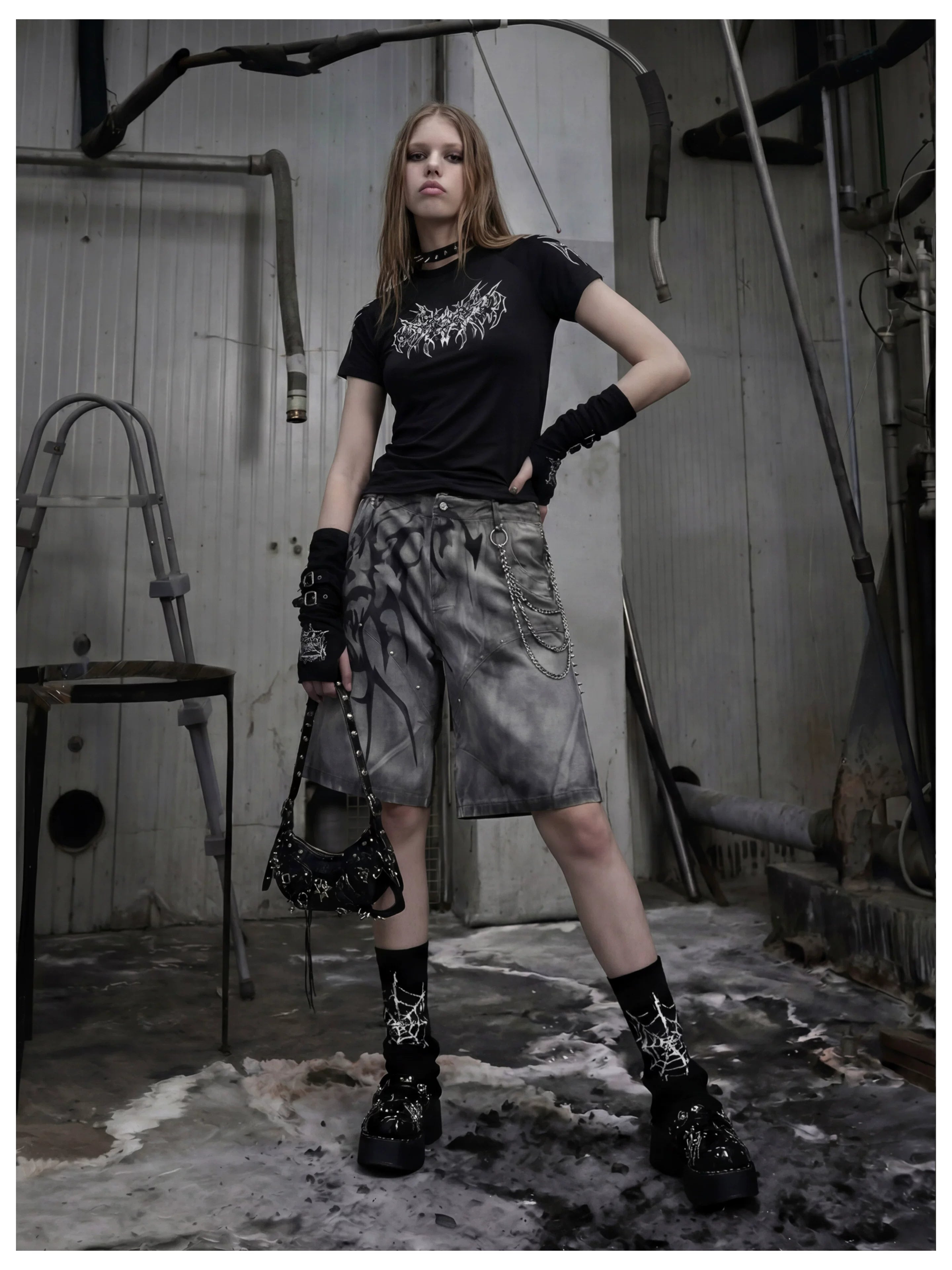 NOMANIAI Y2K loose-fit denim shorts with hand-drawn motifs and studs.